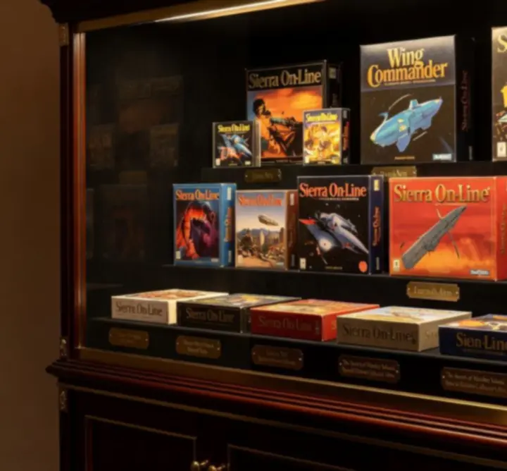 Vitrine illuminée de jeux PC collectors dans un décor sombre et élégant